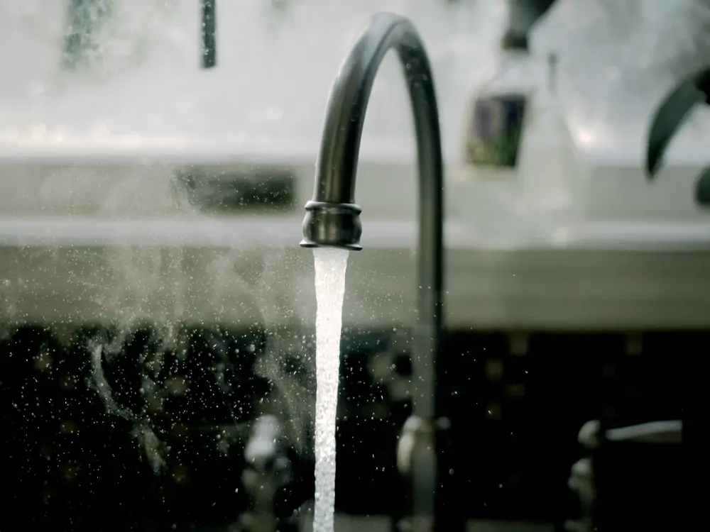 steamy hot water running from sink faucet