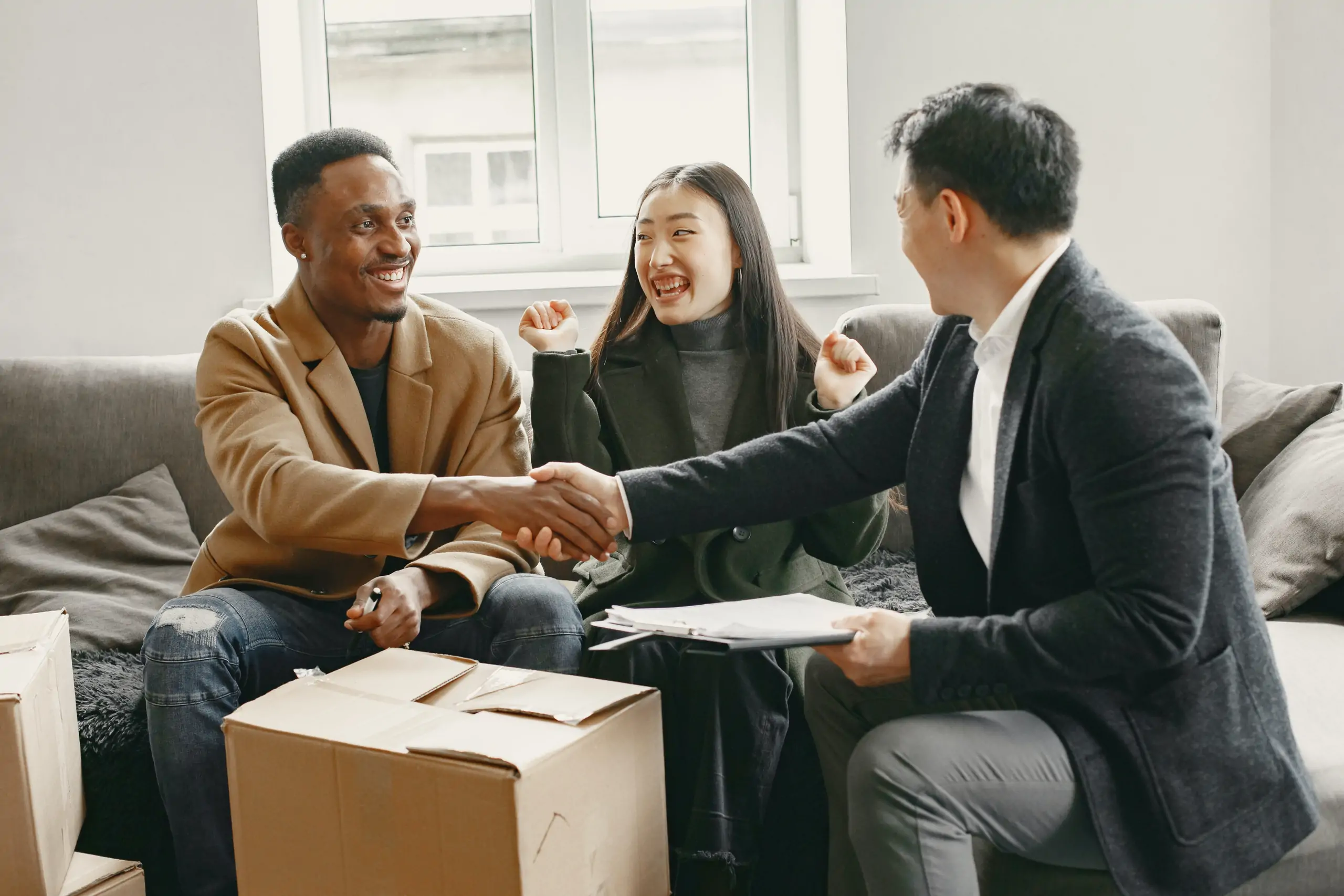 a young couple making a deal with a businessman